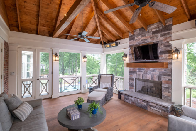 porch-screened-interior-fireplace-mantel-screen-door-southern-cross-railing-cypress-flooring-exposed-ceiling
